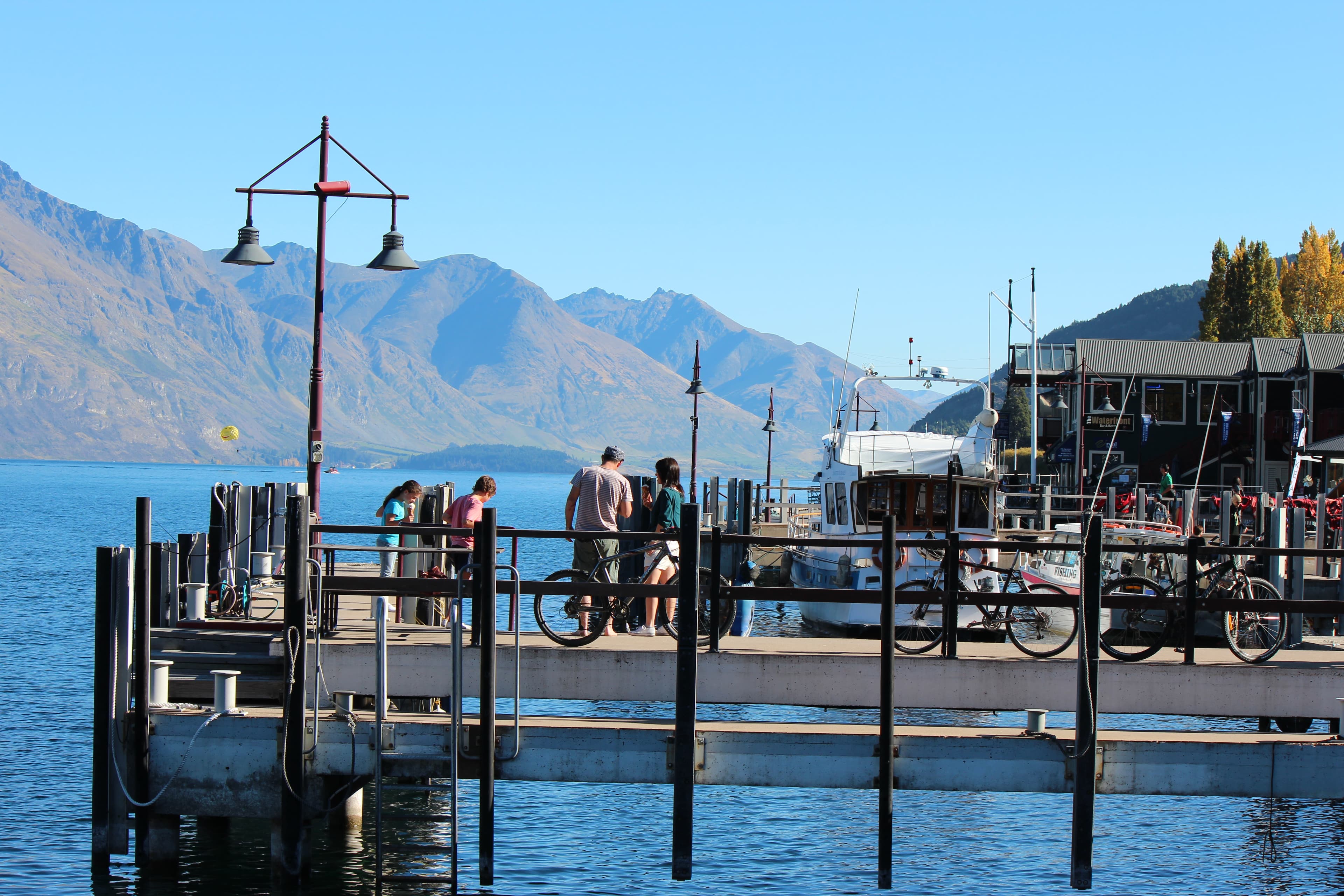 People enjoying a sunny wharf on a Central Otago lake